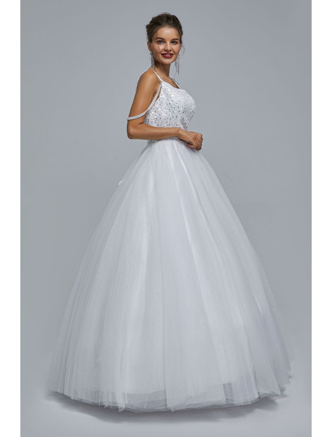 Side view of elegant spaghetti strap ball gown for formal occasions.