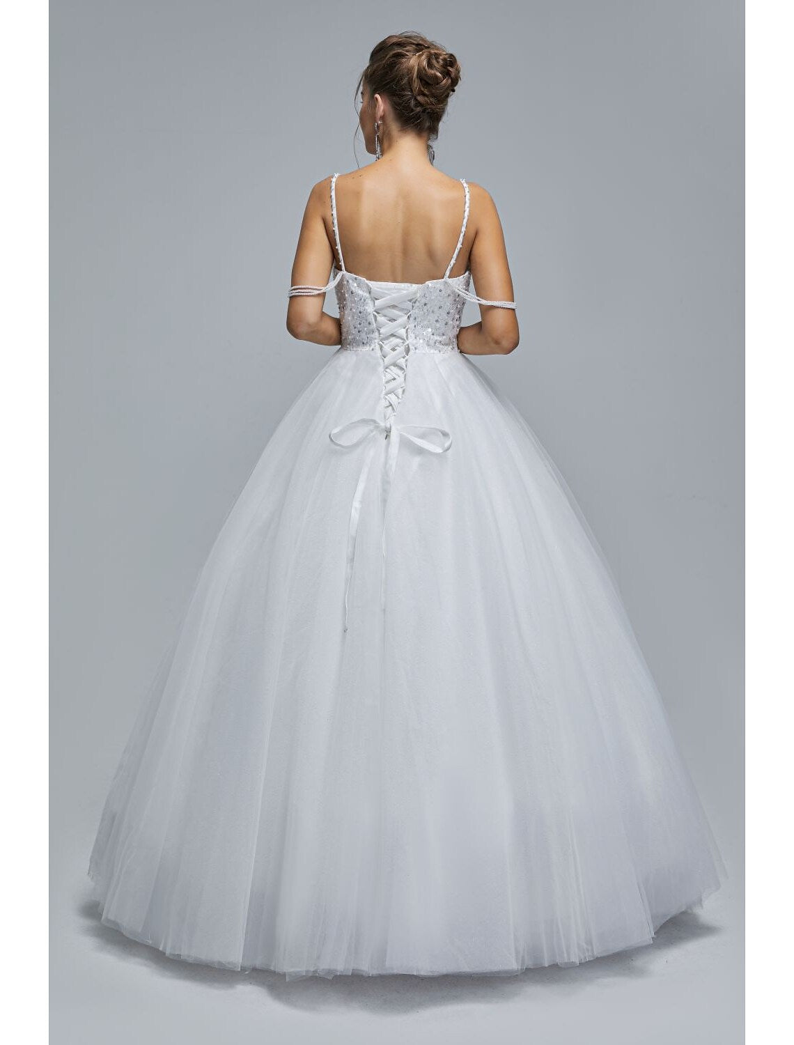 Model wearing a shimmering floor-length graduation ball gown.