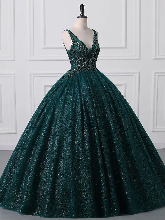 Side view of a woman in a floor-length tulle ball gown with shimmering details.