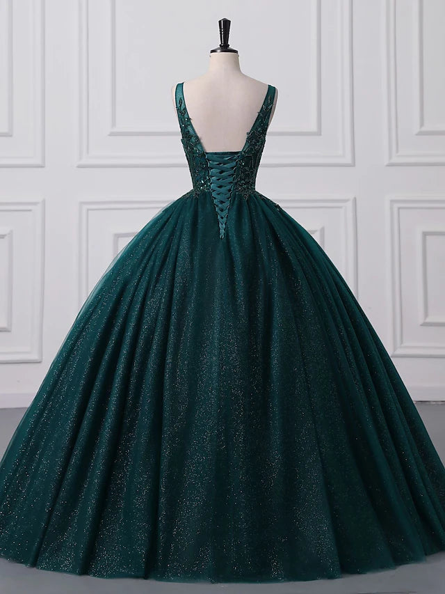 Woman posing in a dazzling ball gown, highlighting the tulle skirt.