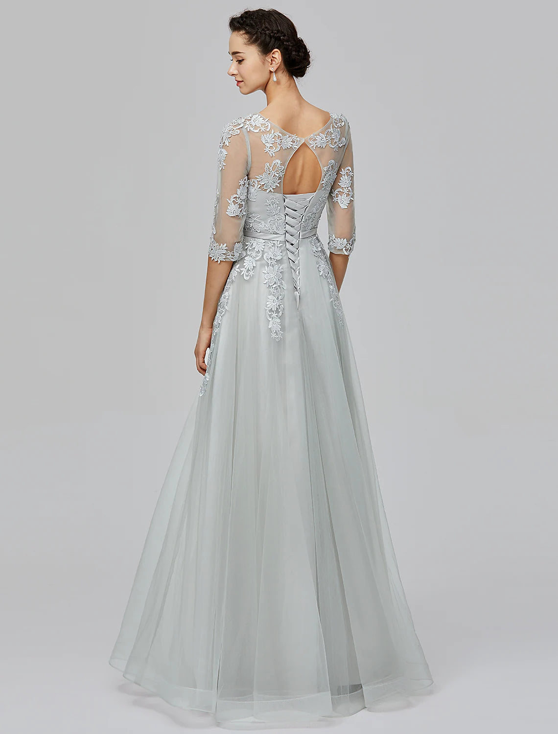 Close-up detail of the illusion neckline and half sleeve on the formal gown.
