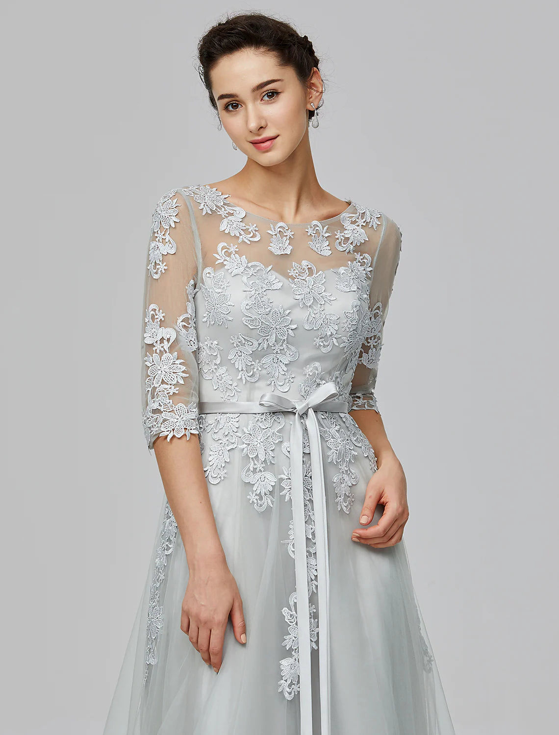 Detailed view of the bow appliques on the back of the Empire waist dress.