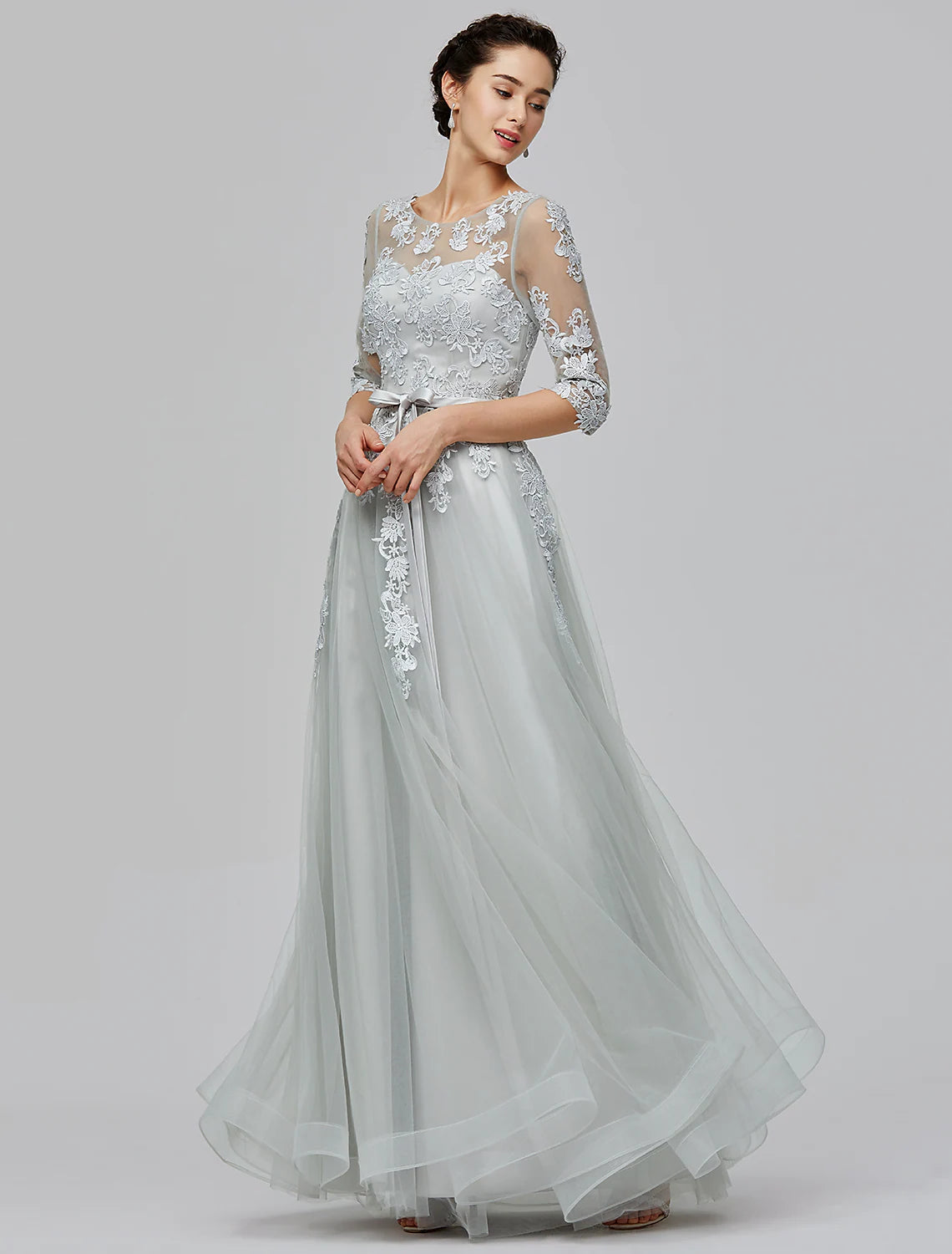 Model wearing the A-Line Empire dress, highlighting its floor length design and graceful flow.