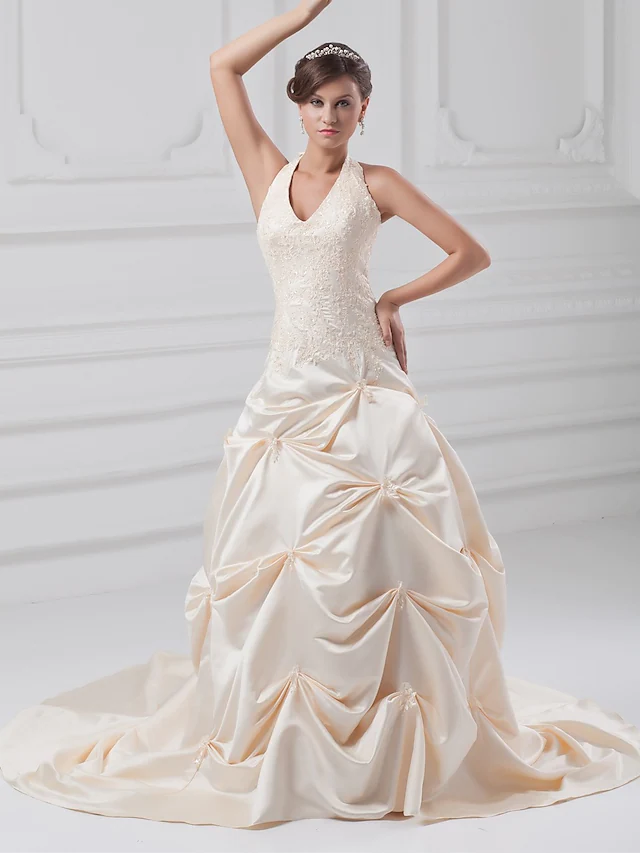 White A-line wedding dress with halter neck and chapel train.