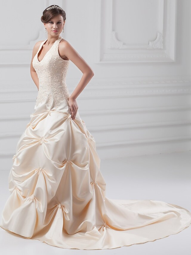 Back view of A-line wedding dress showing chapel train and lace details.