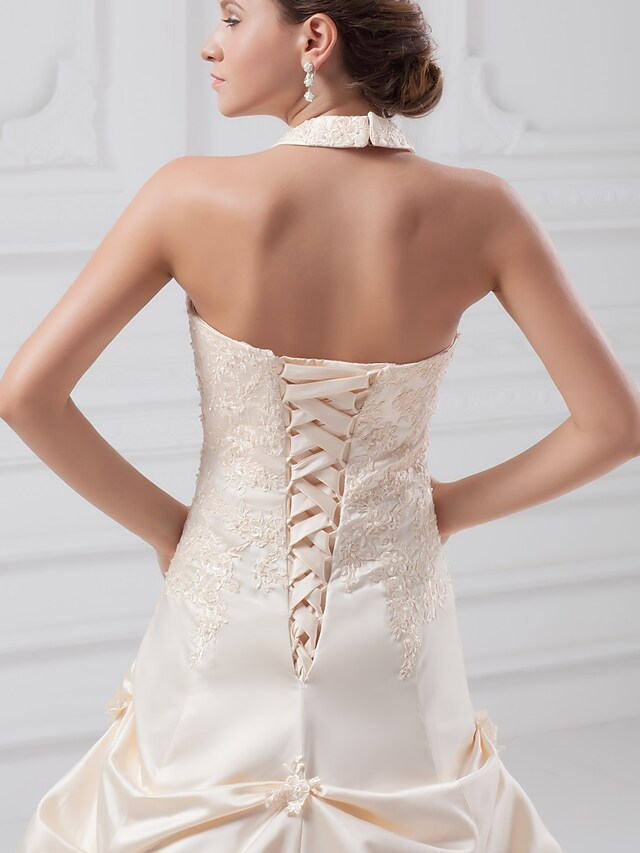 Elegant A-line bridal gown with intricate beading and appliques.