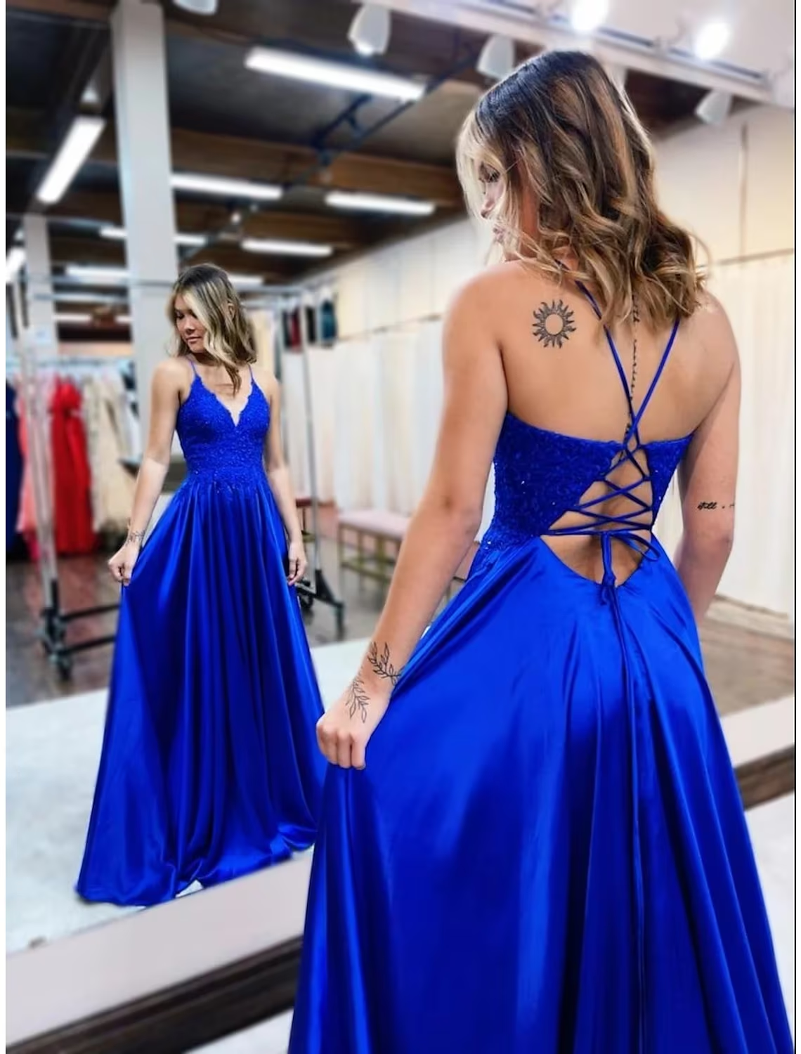 Close-up of the V-neck bodice with intricate beading and appliques on a light blue satin prom dress.