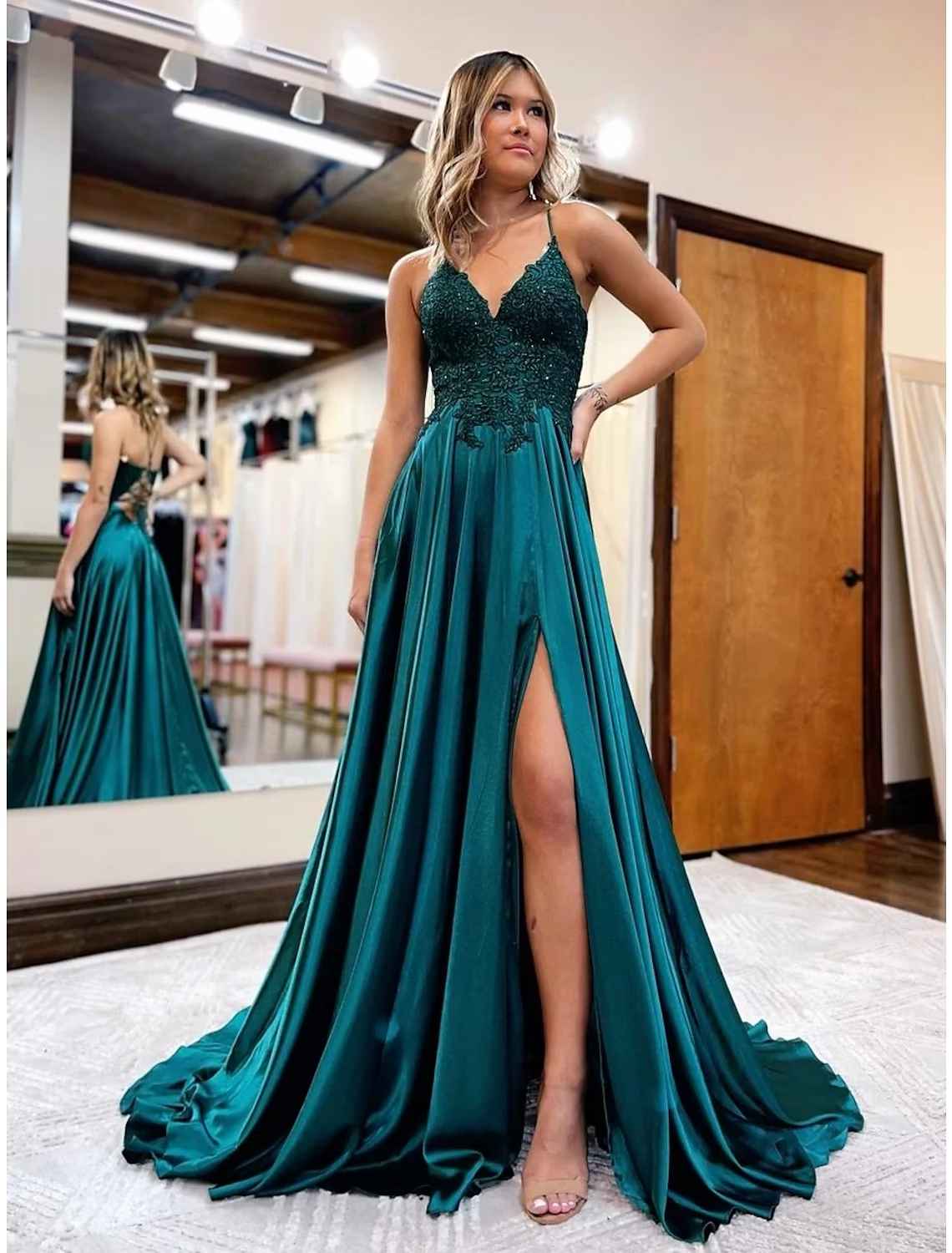 Side profile of a light blue A-Line satin prom dress, showcasing its elegant silhouette and length.
