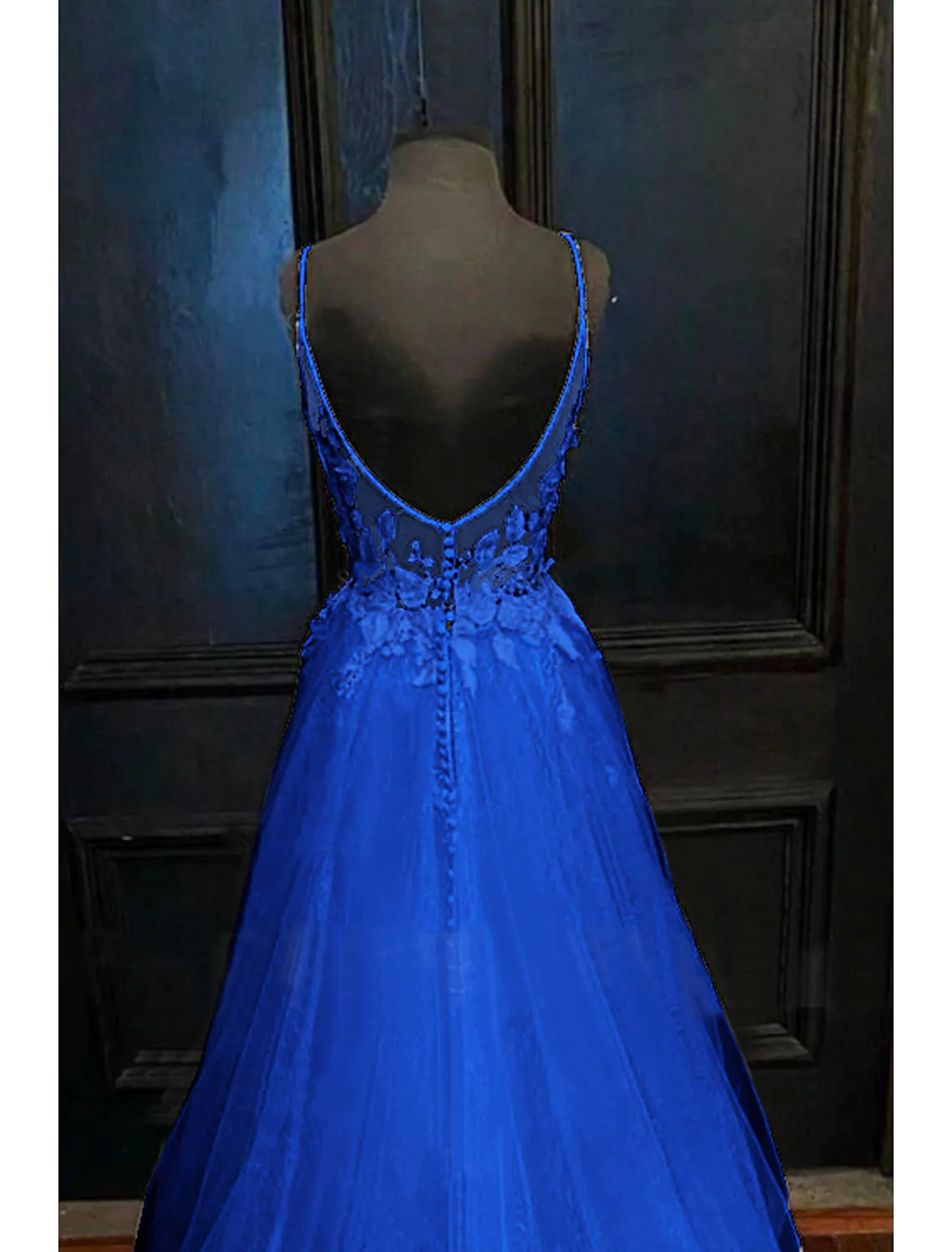Back view of an A-line V-neck tulle prom dress, showcasing the open back design and beading appliques.