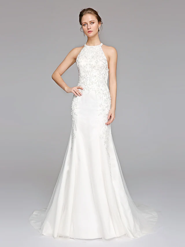 Elegant mermaid wedding dress with halter neckline and lace overlay.