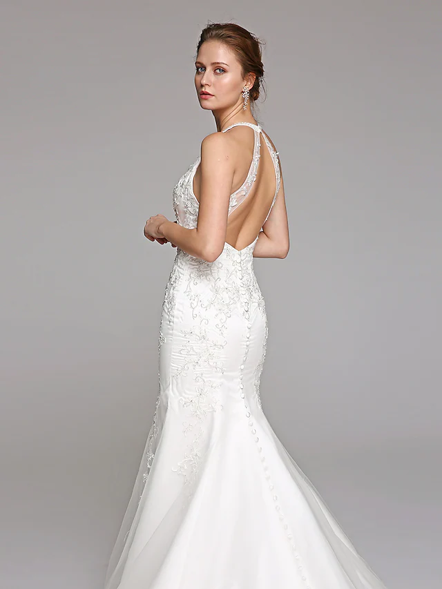 Elegant bridal dress with a halter neckline and backless design.