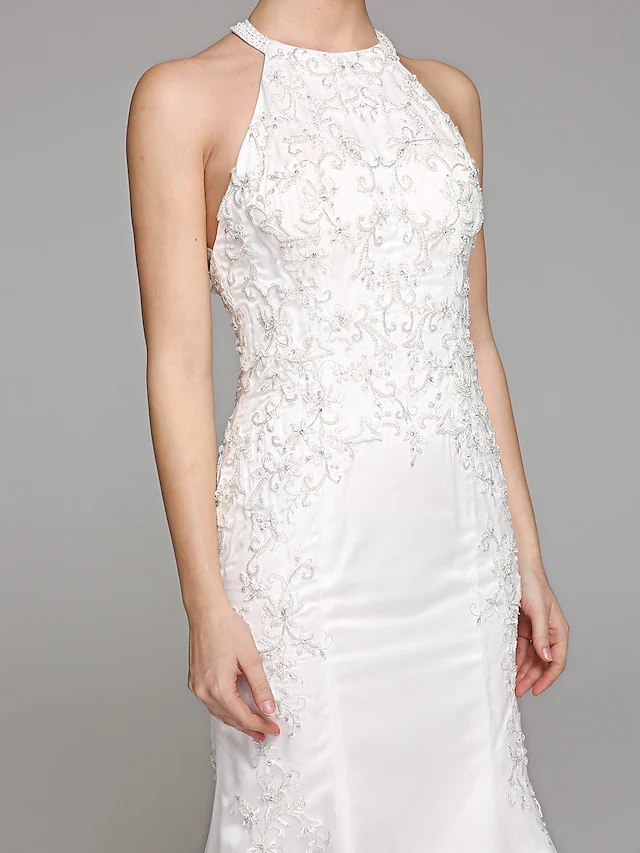 Halter neck wedding gown showcasing illusion back and tulle skirt.