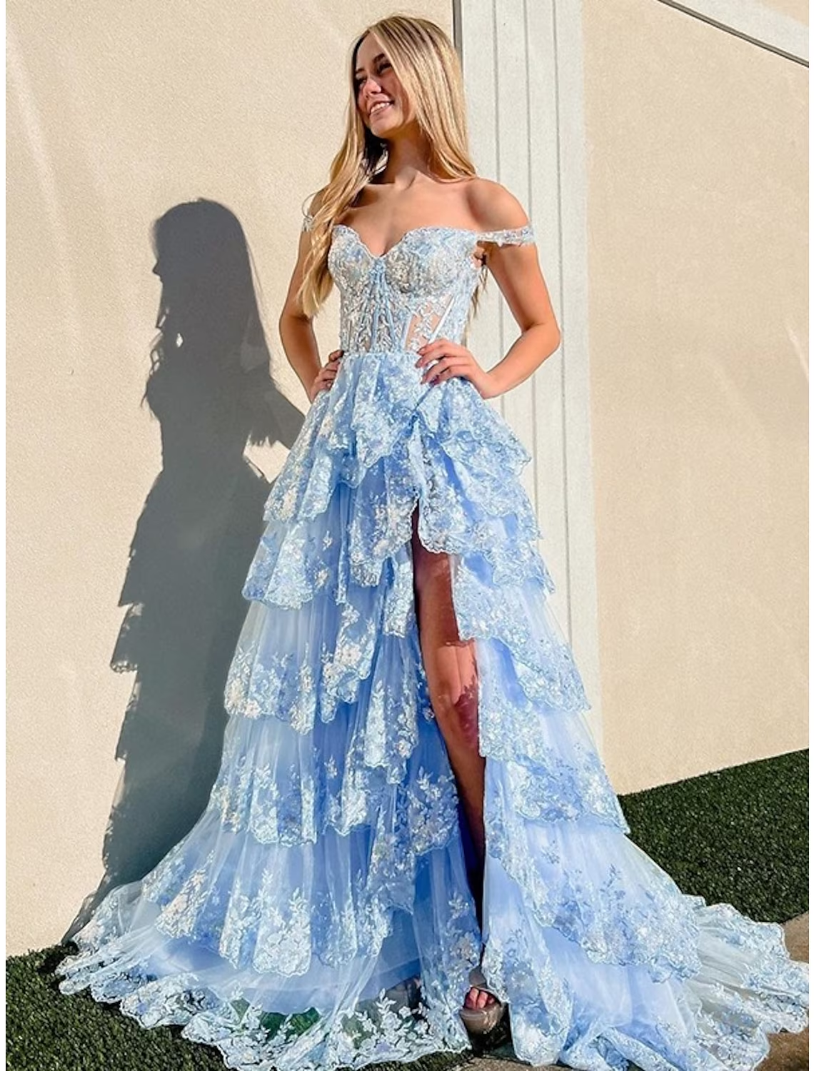 Purple mermaid trumpet prom dress with off-shoulder neckline and sequin slit.