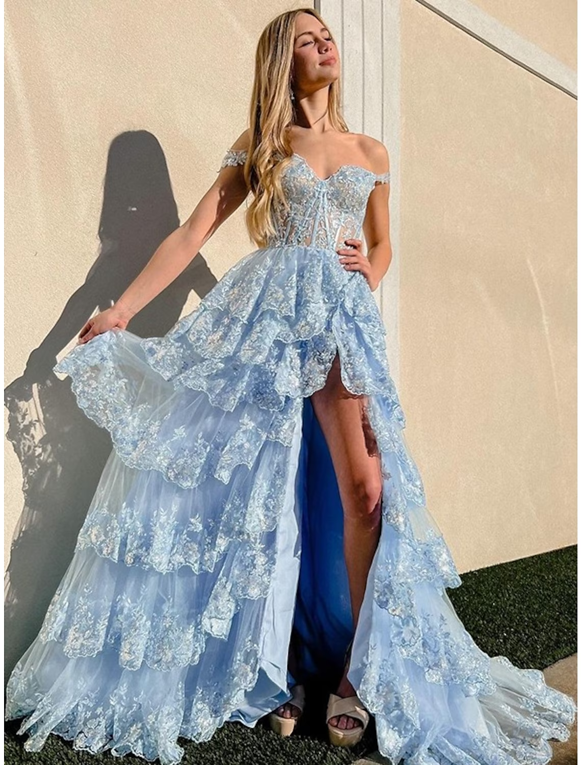 Green mermaid trumpet prom dress with off-shoulder neckline and sequin slit.