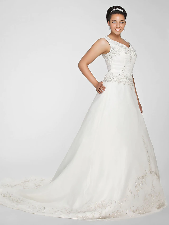 Close-up of beaded lace details on V-neck wedding dress.