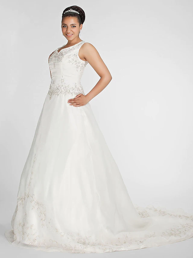 Side view of bride wearing a formal ball gown wedding dress.