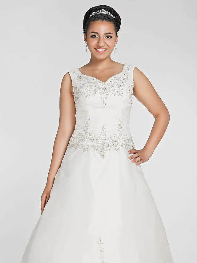 Full length view of a white organza wedding dress.