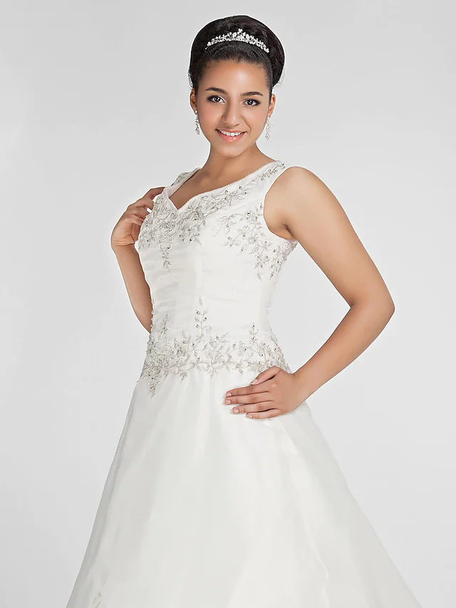 Detail of embroidery and beading on bridal gown.