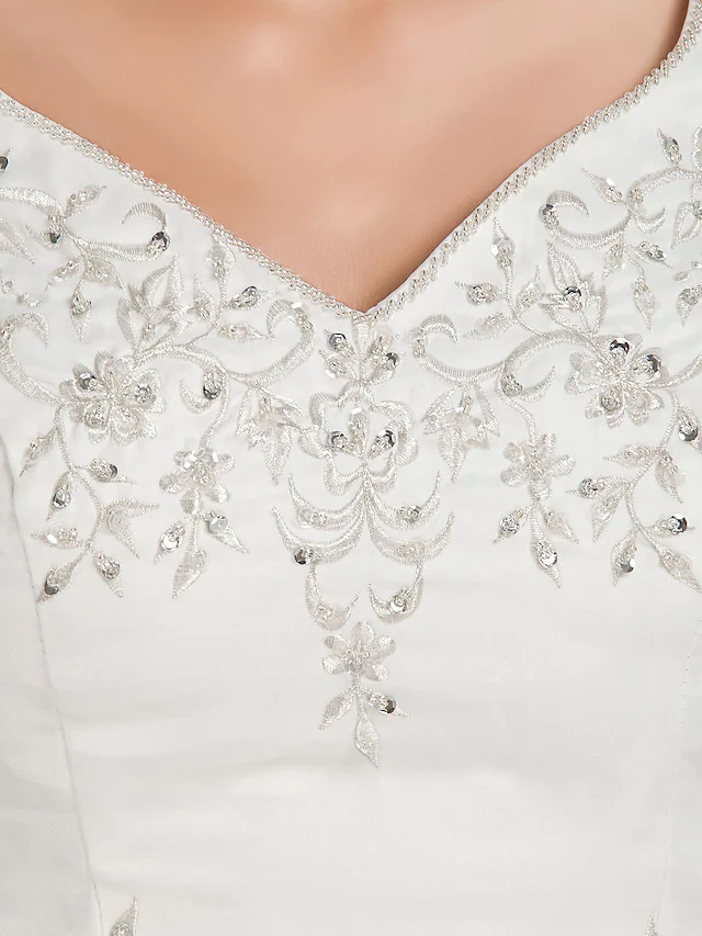 Flowing court train of a ball gown wedding dress.