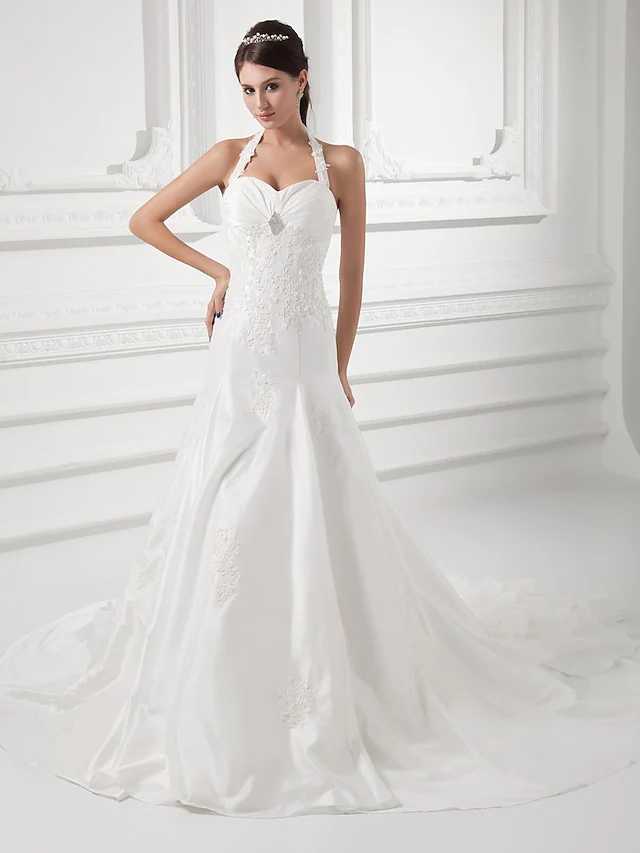 A-Line halter neck wedding dress with ruched bodice and beading appliques.