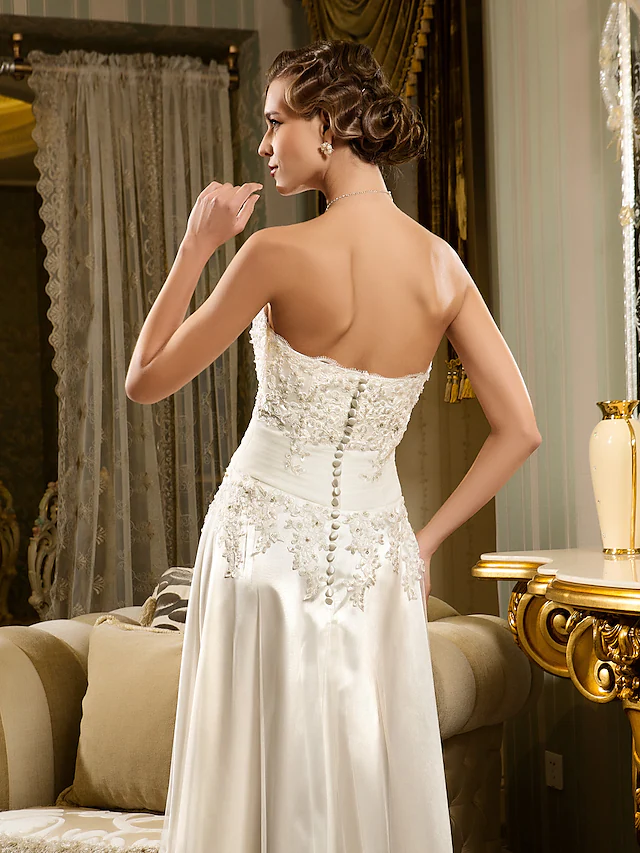 Detail of appliques and fabric texture on the wedding dress.