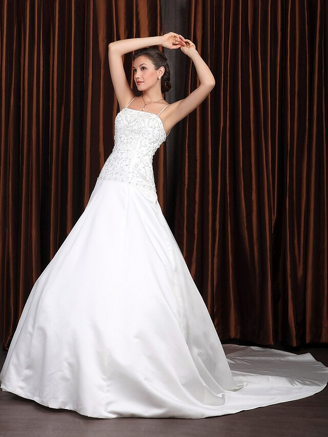 Back view of vintage A-Line wedding gown with intricate beading appliques and long train.