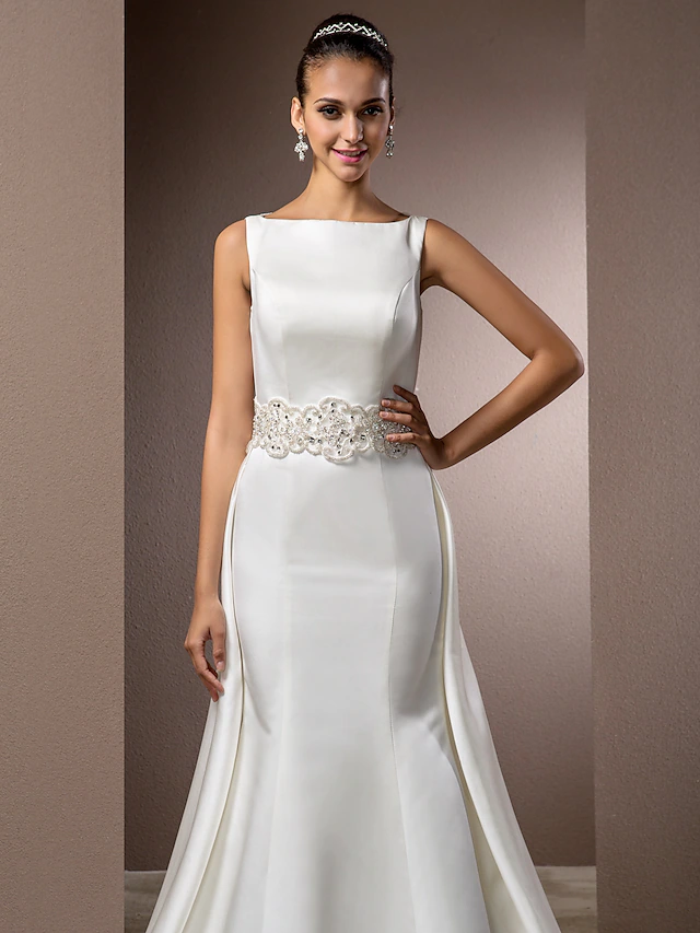 Full length view of elegant satin wedding dress.