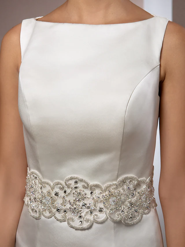Detail of the bateau neckline and regular straps on wedding dress.